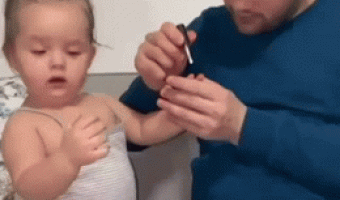 Father paints his daughter’s nails