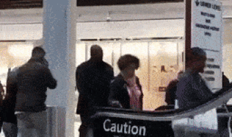 Boys playing on escalators