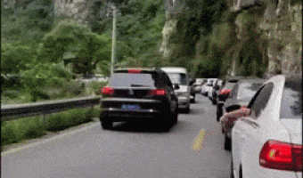 Woman tries to pass the line of cars
